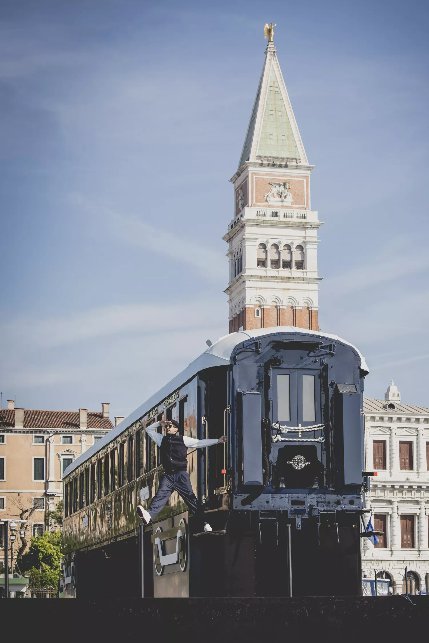 JR hanging out of L'Observatoire, Venice Simplon-Orient-Express, A Belmond Train, Europe; credit - JR
